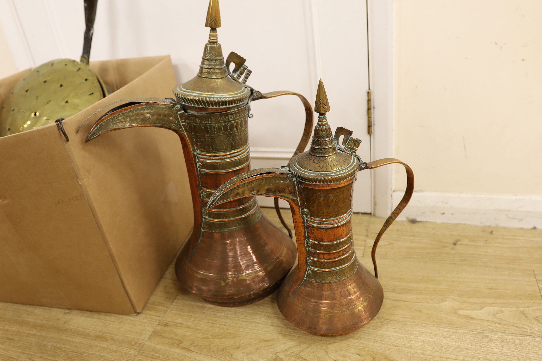 A collection of Middle Eastern copper and brassware, including two large Arabic Dallah